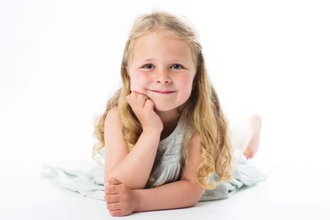 Minimalistisk børneportræt med naturligt smil